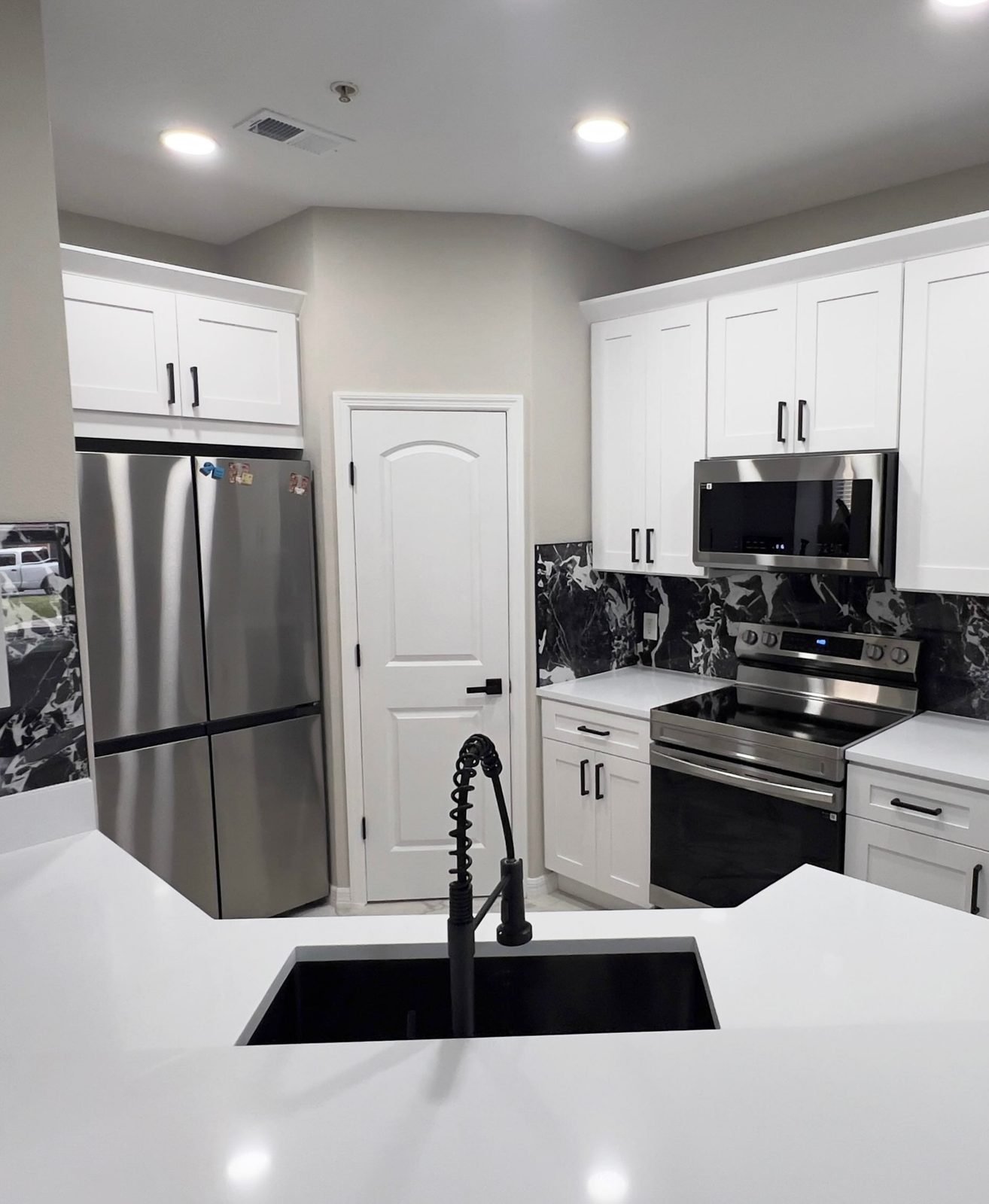 White shaker cabinetry with quartz counters and marble backsplash, Orlando FL